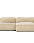 The Baker Modular Sofa | Fabric • M4 by Wooden Stories is a contemporary beige sofa with a low backrest, wide right armrest, and left chaise lounge featuring plush feather filling, shown against a white background.