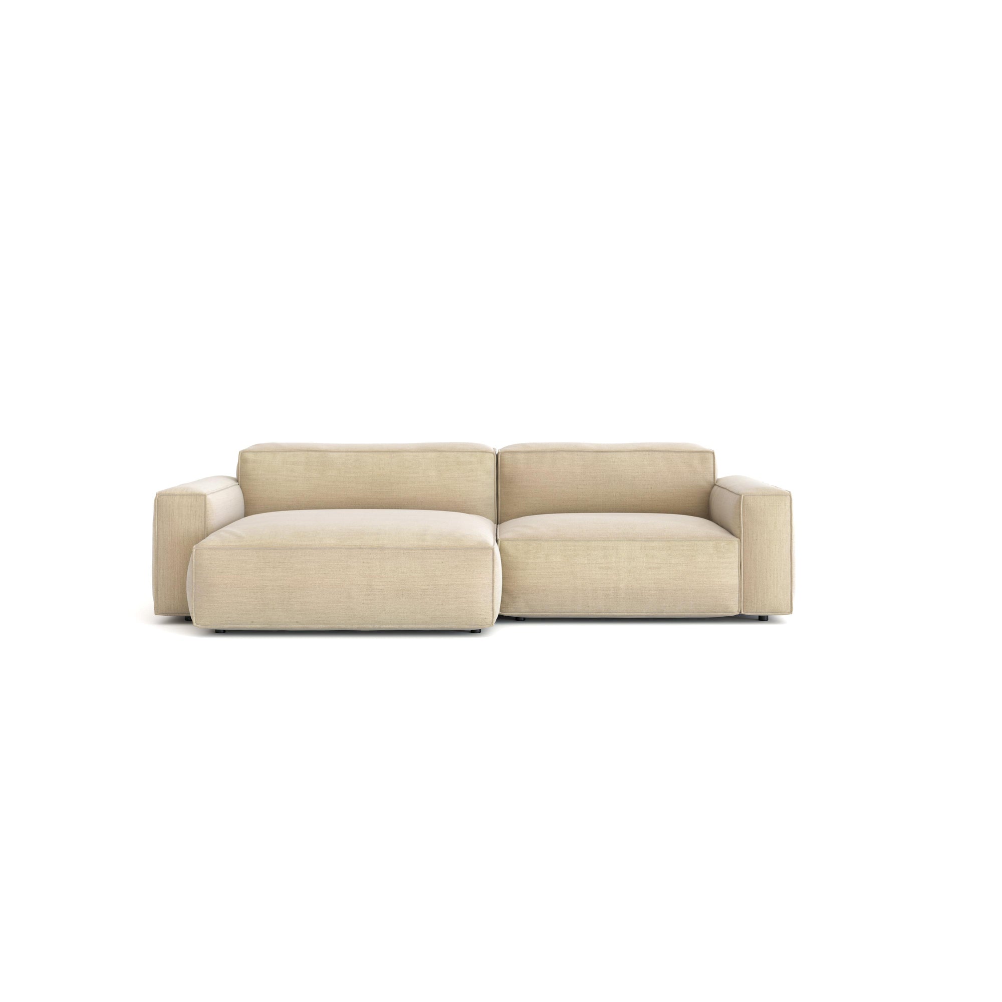 The Baker Modular Sofa | Fabric • M5 by Wooden Stories is a modern beige two-seater with plush boxy cushions and wide armrests, set against a plain white background—a contemporary furniture statement.
