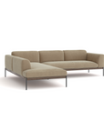 The Department Modular Sofa | Fabric • M6 by Wooden Stories features beige upholstery, low-profile cushions, and slim black metal legs in a modern L-shaped design inspired by Danish collections, set against a plain white background.