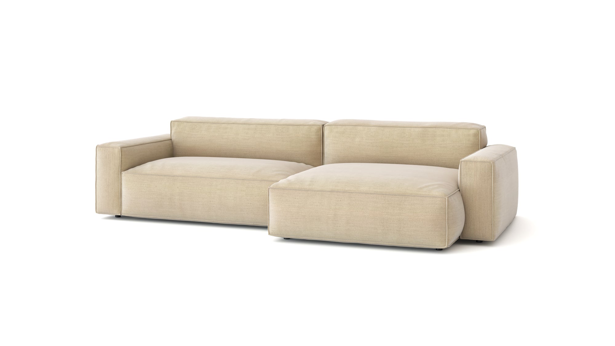 The Baker Modular Sofa | Fabric • M6 by Wooden Stories is a modern beige sofa with wide armrests, plush feather-filled cushions, and a right-side chaise lounge, shown isolated against a white background.