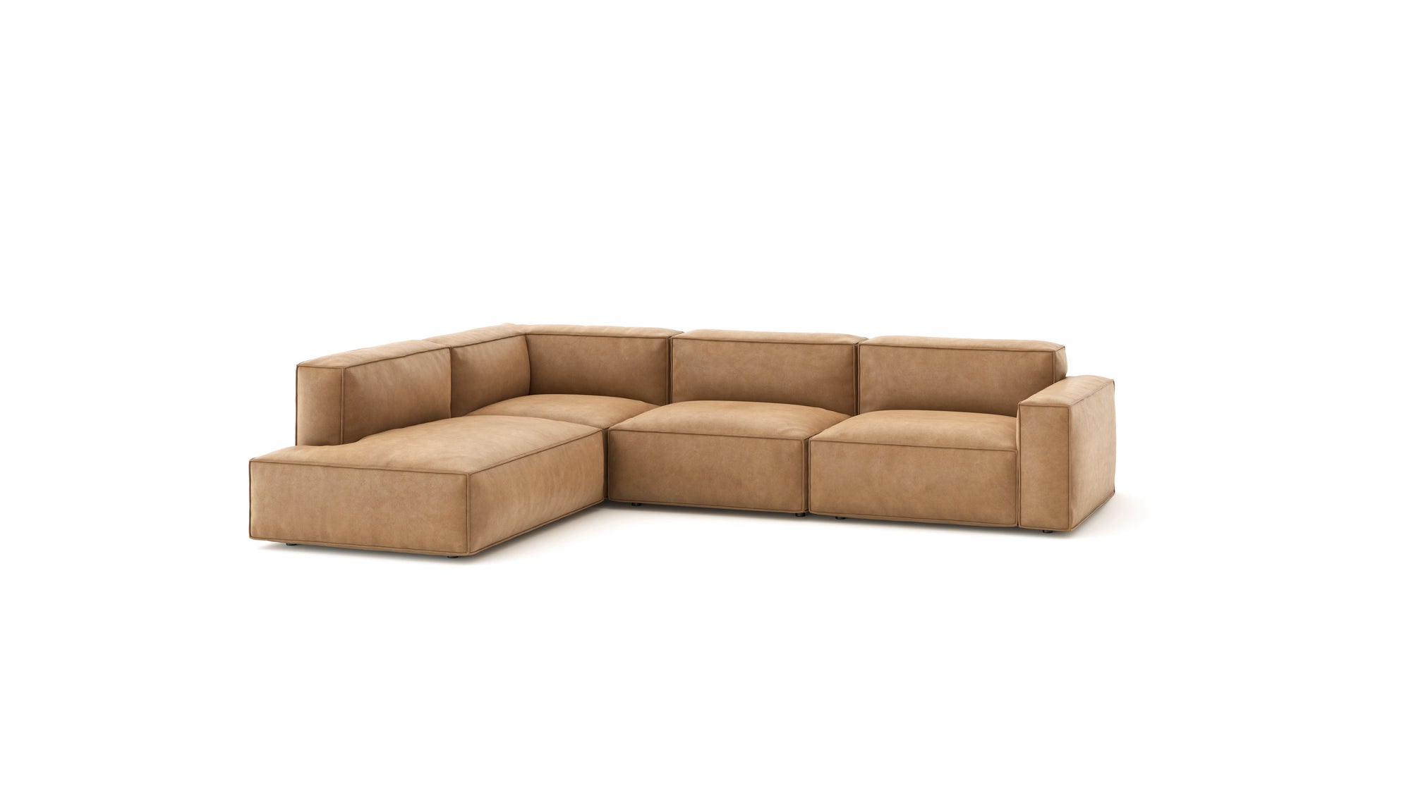 The Baker Modular Sofa | Leather • M7 by Wooden Stories is an L-shaped, light brown leather sofa with wide armrests and low backrests, ideal for any contemporary setting.