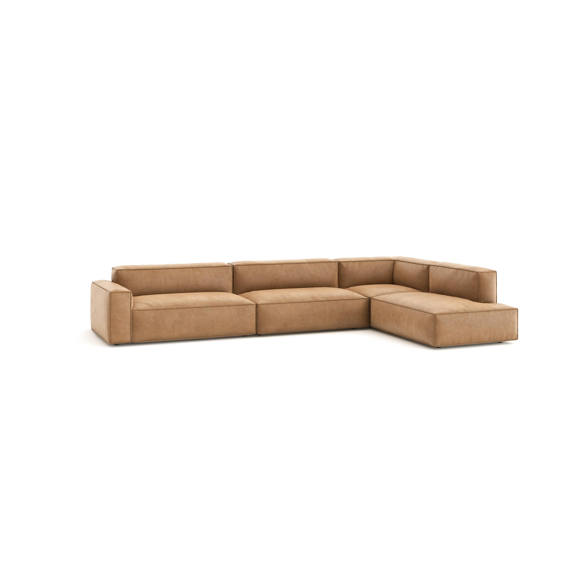 The Baker Modular Sofa | Leather • M8 by Wooden Stories is a large, L-shaped contemporary sofa in light brown leather with wide, cushioned seats and backrests, shown against a plain white background.