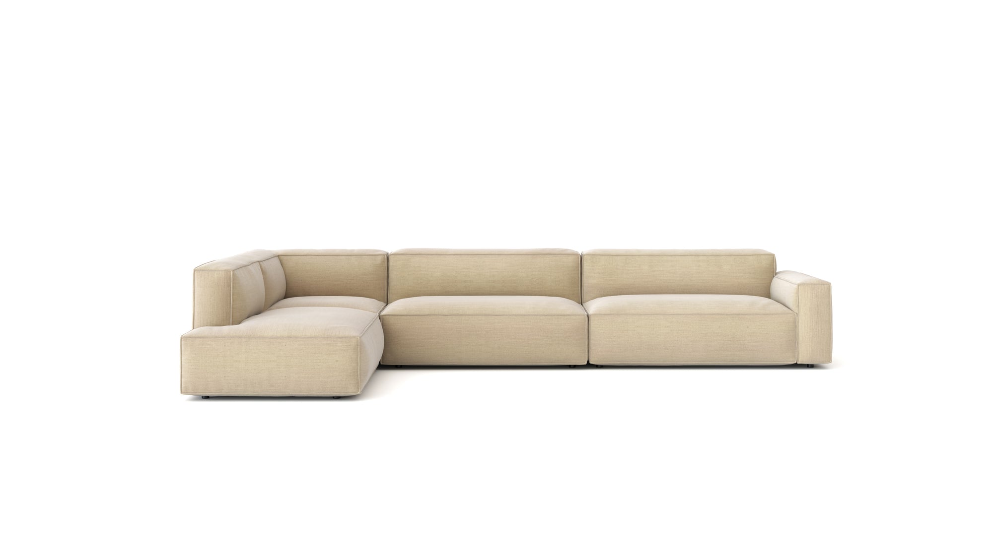 The Baker Modular Sofa | Fabric • M8 by Wooden Stories is a contemporary L-shaped sectional with low, wide arms and plush feather-filled cushions, shown against a plain white background.