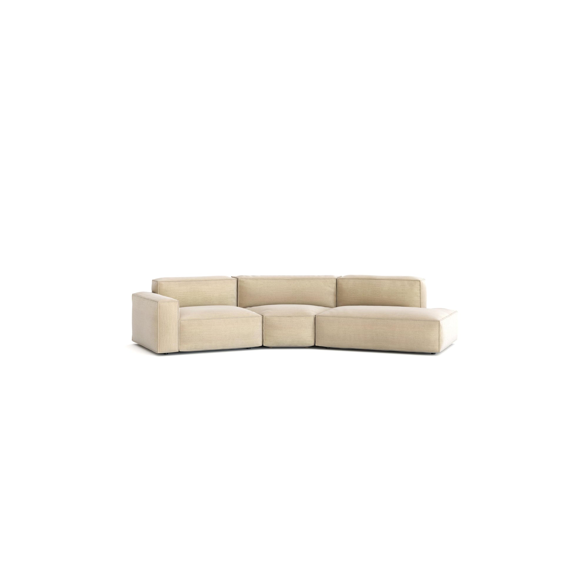 The Baker Modular Sofa | Fabric • M9 by Wooden Stories is a modern beige three-seater with thick cushions, low armrests, and a slight curve, shown against a plain white background.