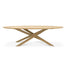 The Ethnicraft Mikado Dining Table Oval - Oak features a modern European oak top and a distinctive intersecting base, shown against a white background.