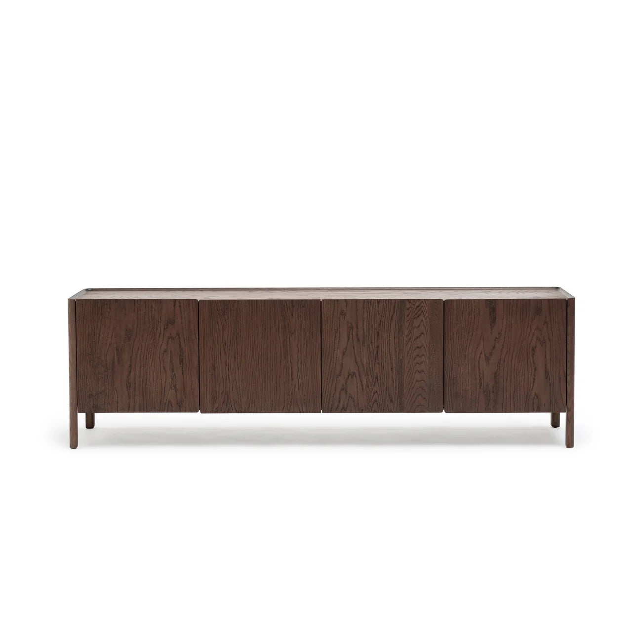 The Wooden Stories Nell Sideboard | Espresso Oak showcases four doors, clean minimalist lines, and a modern dark wood finish inspired by Scandinavian design. It stands on four short legs, set against a white backdrop.