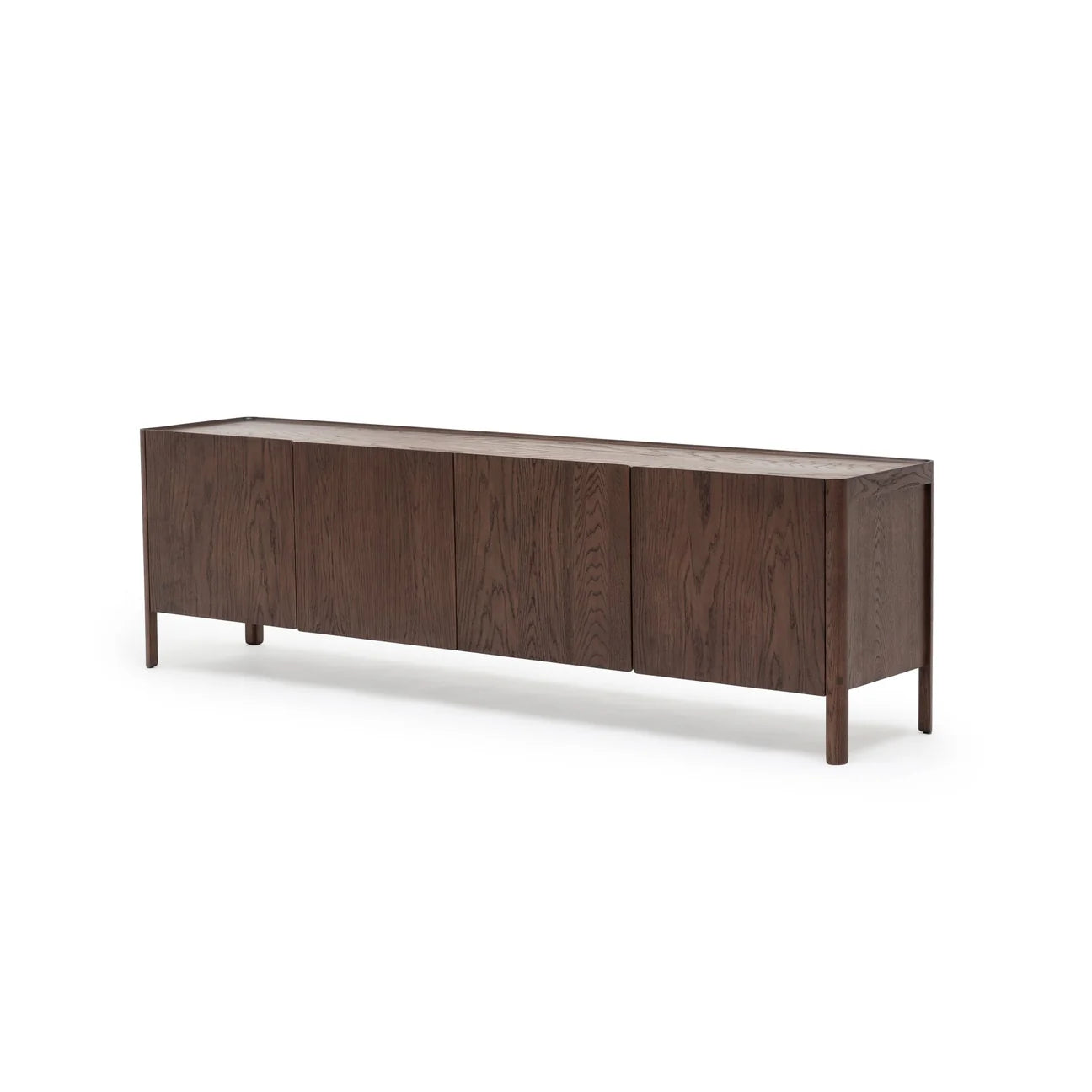 The Wooden Stories Nell Sideboard | Espresso Oak showcases a modern Scandinavian design with four doors, crafted from dark solid oak and elevated on slim legs, all set against a plain white background.