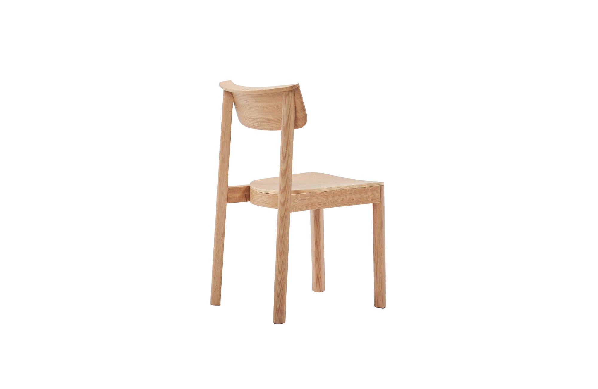The Noki Dining Chair | Light Oak by Wooden Stories is a minimalist solid wood chair with a curved backrest and straight legs, shown angled against a plain white background.