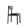 The Noki Dining Chair by Wooden Stories features a modern minimalist design in black oak with a padded leather seat and backrest, straight legs, and contract-grade solid wood construction, shown against a white background.