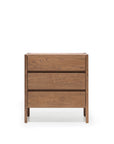 The Nell Tall Dresser by Wooden Stories, part of the Danish Collection, is a wooden dresser with three drawers displayed against a plain white background. It showcases a simple, modern design with visible wood grain patterns and is equipped with premium metal runners for smooth operation—making it an ideal addition to any bedroom storage setup.