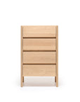 The Nell Tall Dresser by Wooden Stories from the Danish Collection is a light wood dresser featuring four horizontal drawers, viewed from the front and standing on short legs against a white background. This elegant piece provides premium bedroom storage, offering smooth and reliable drawer operation with its high-quality metal runners.