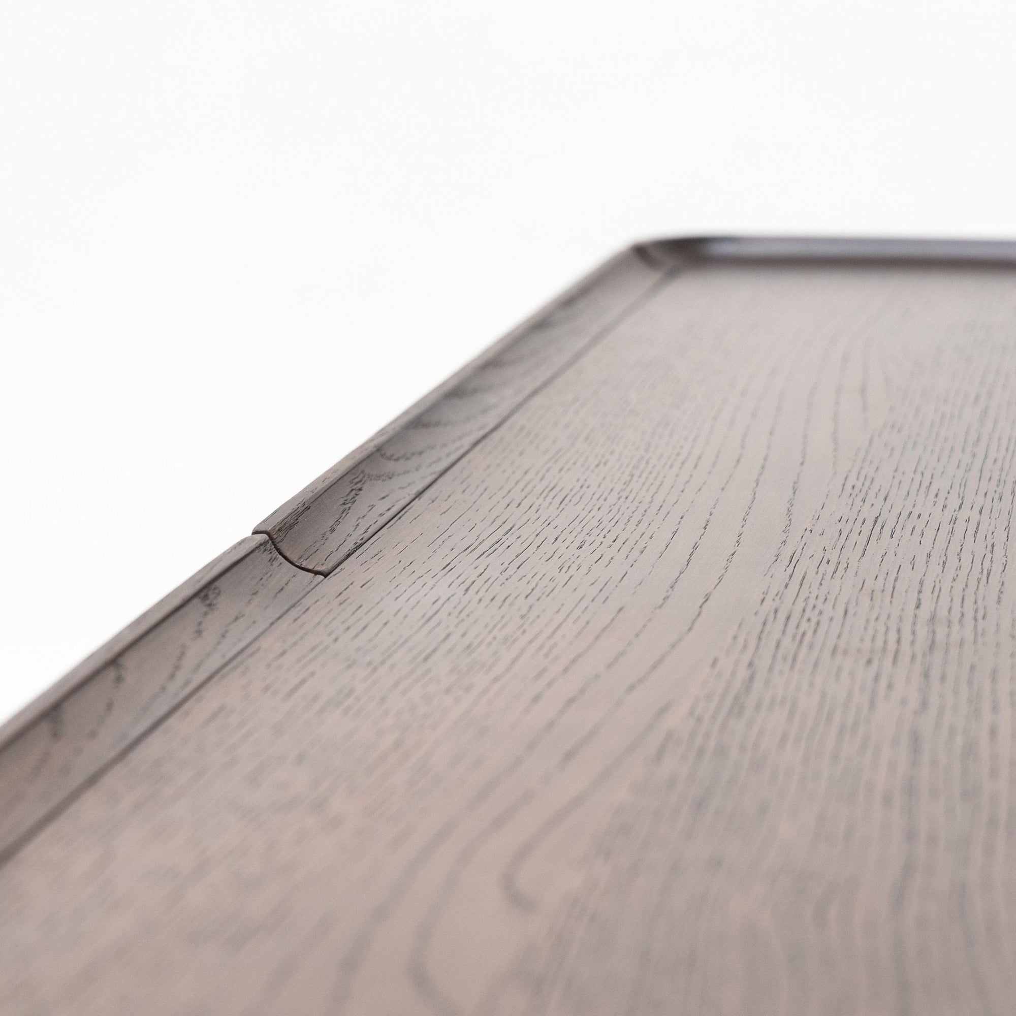 Close-up of the Nell Console by Wooden Stories in Espresso Oak with Stone, highlighting its smooth texture and visible wood grain against a plain white background, inspired by Scandinavian design.