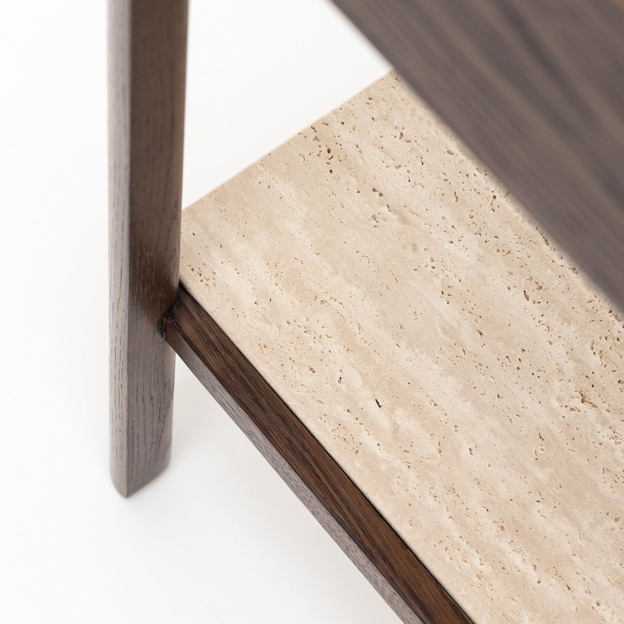 Close-up of the Nell Console by Wooden Stories, featuring an espresso oak frame and legs with a light beige stone shelf, shown against a plain white background.