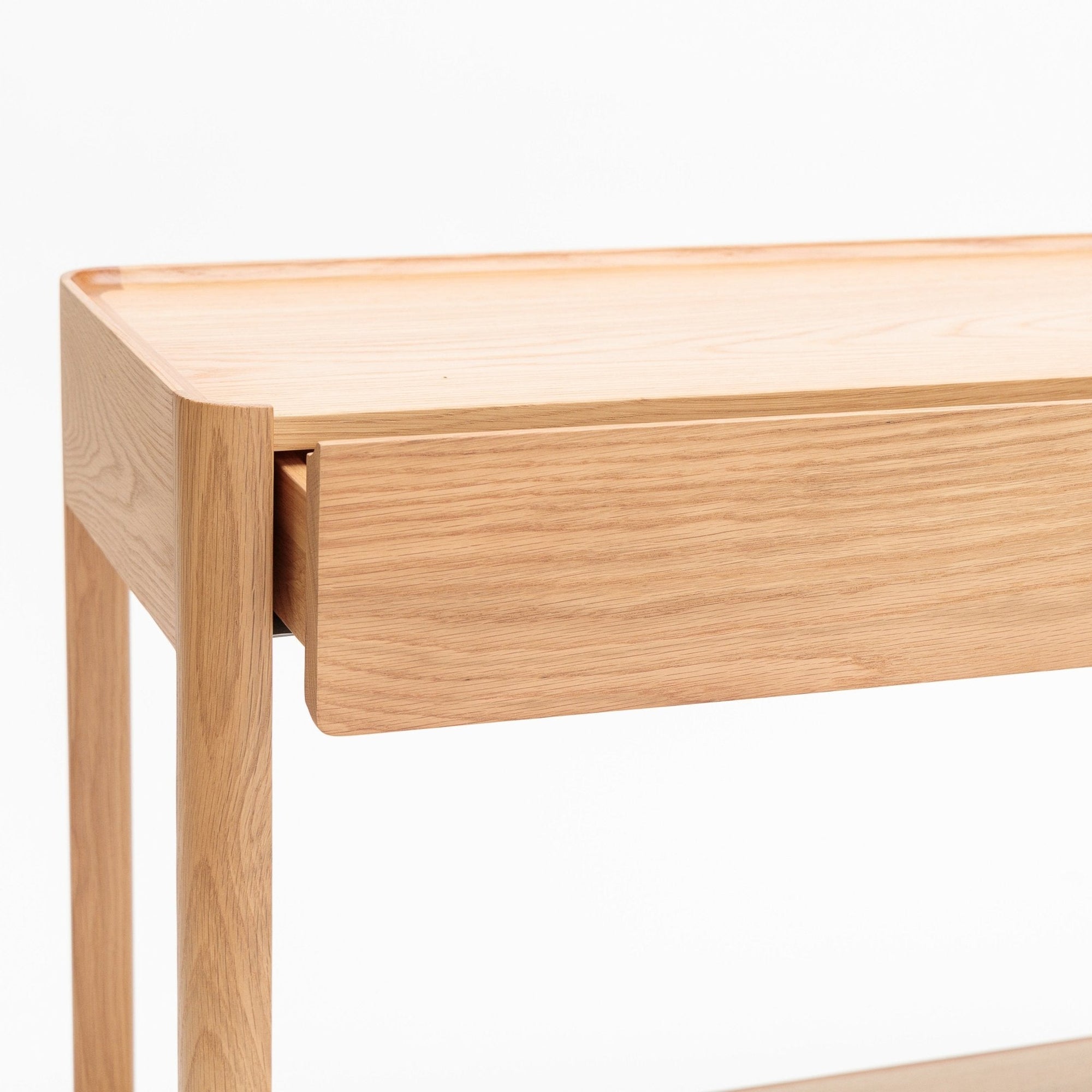 A detailed view of the Wooden Stories Nell Console in light oak with stone, showcasing its minimalist Scandinavian design, clean lines, and smooth surfaces, set against a white background.