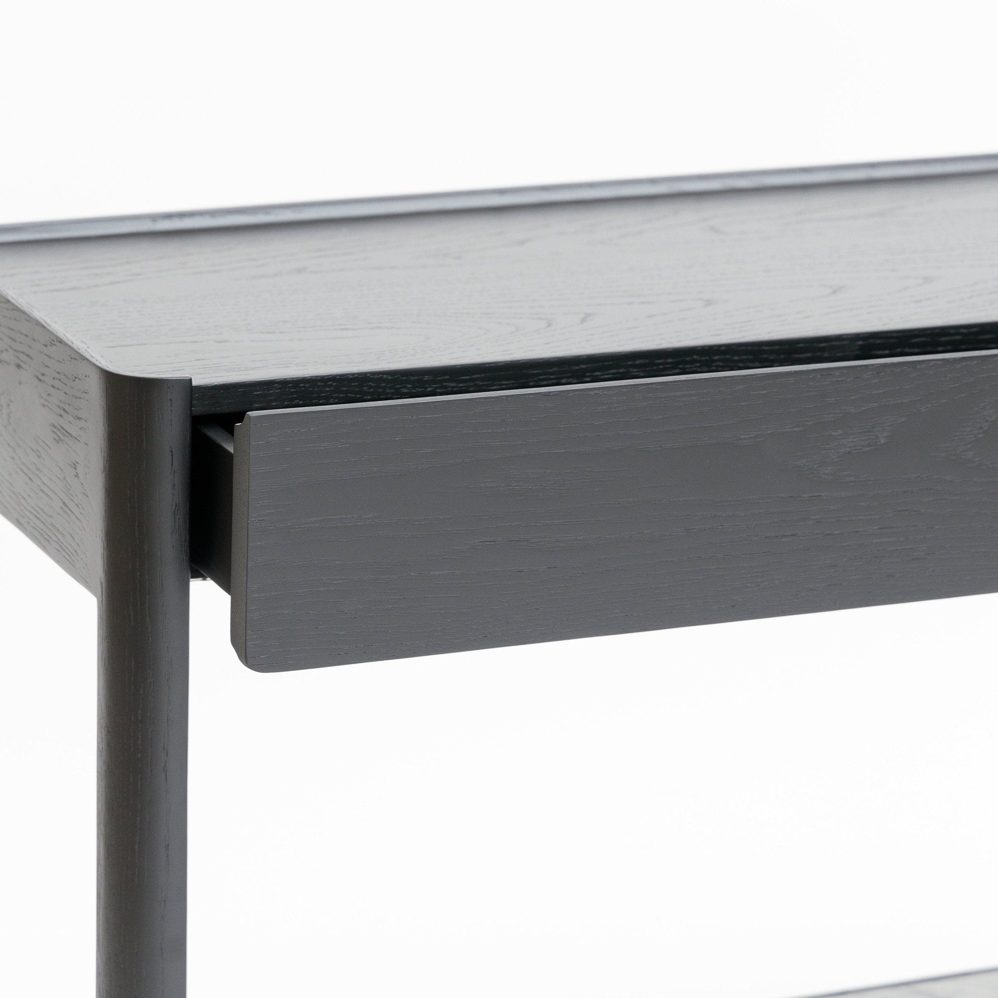 A close-up of the Wooden Stories Nell Console in Black Oak with Stone, featuring a single drawer partially open, set against a plain white background.