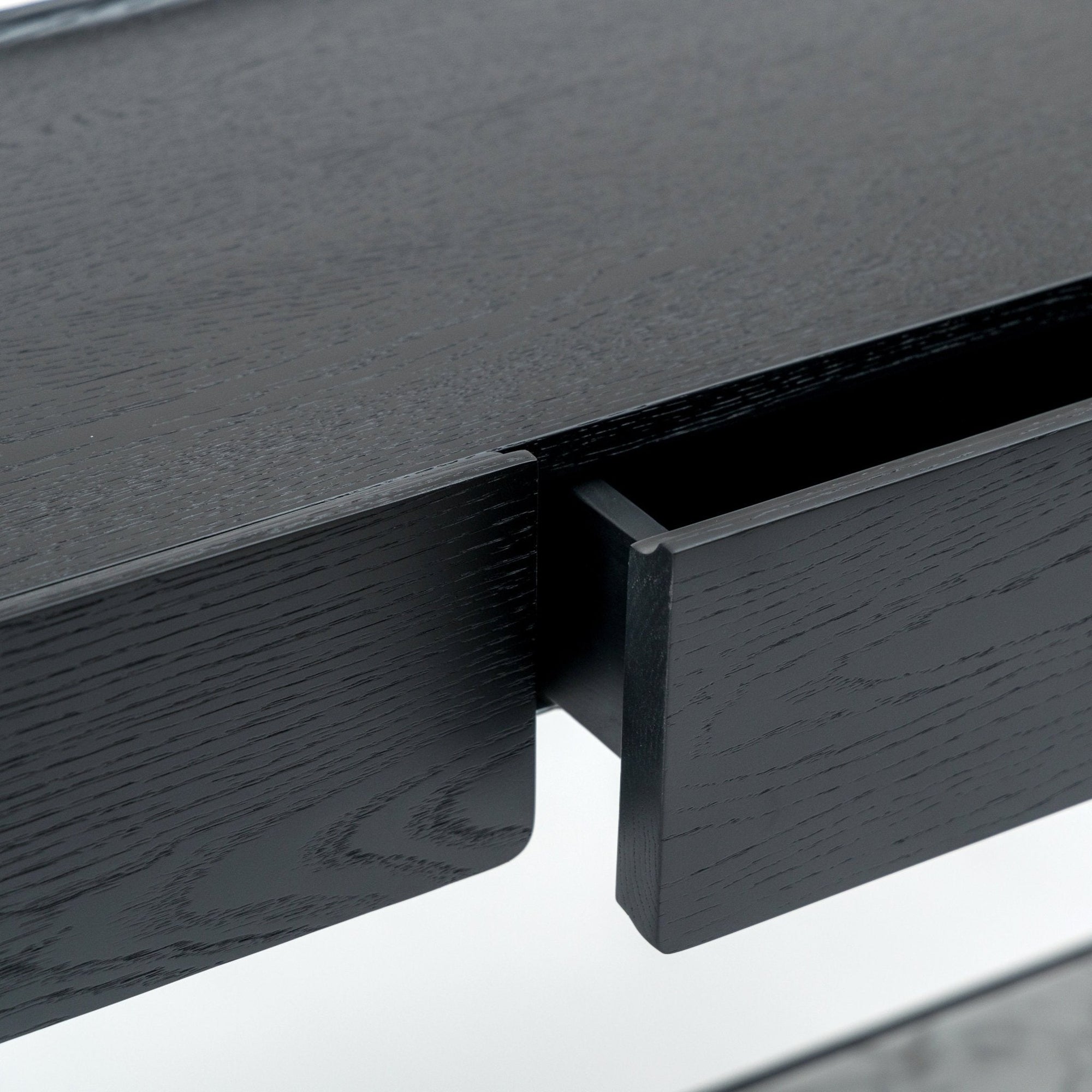 Close-up of the Wooden Stories Nell Console in Black Oak with Stone, featuring a single drawer partially open to showcase the rich wood grain and modern, minimalist Scandinavian design.