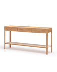 The Wooden Stories Nell Console in Light Oak with Stone features three soft-close drawers, a lower open shelf, and a minimalist Scandinavian design with a natural finish, shown against a plain white background.