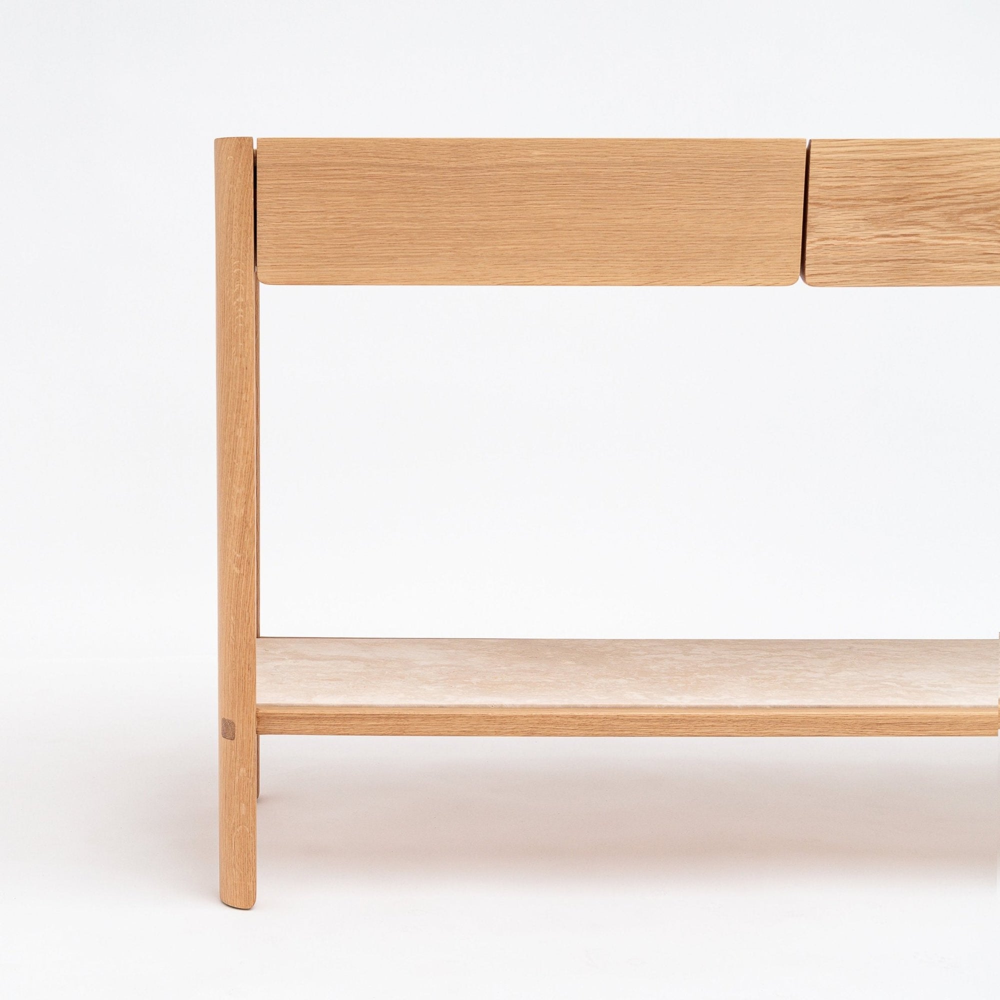 The image shows the right side of the Wooden Stories Nell Console in Light Oak with Stone—a minimalist Scandinavian table with clean lines, a lower shelf, and two drawers—set against a plain white background.