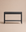 The Nell Console in Black Oak by Wooden Stories, from the Danish collection, is a minimalist piece featuring two drawers, a lower shelf, and rounded legs, styled against a solid neutral beige background.