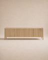 The Nell Sideboard | Blonde Oak by Wooden Stories is a minimalist wooden sideboard featuring four flat-panel doors, set against a beige background. Crafted from solid oak with a natural blonde finish, the cabinet showcases clean, straight lines and a modern, simple aesthetic inspired by Scandinavian design principles.