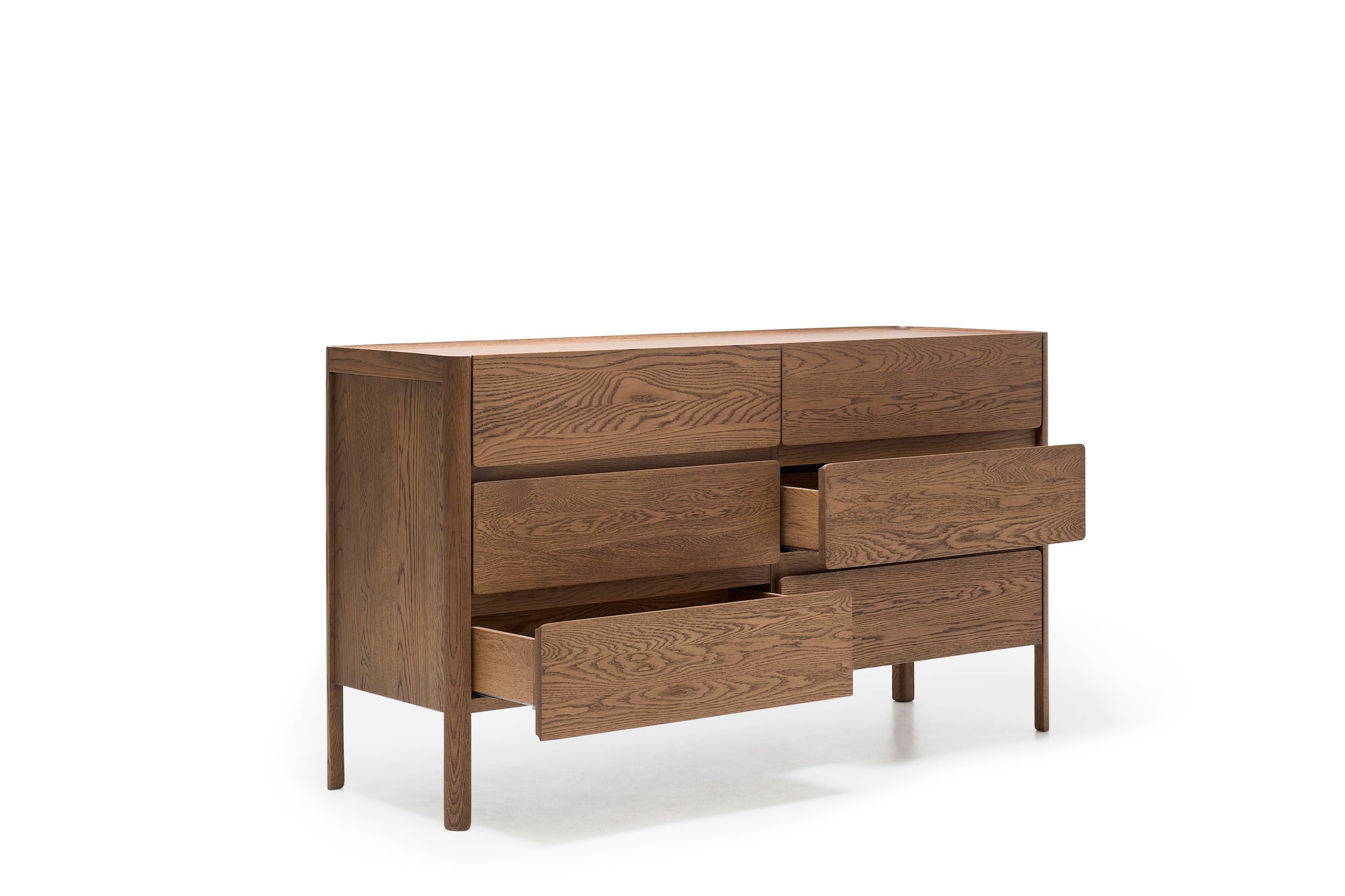 The Wooden Stories Nell Wide Dresser showcases minimalist design and fine timber joinery as part of the Danish Collection. Featuring six wooden drawers—three partially open—it stands on four legs against a plain white background, offering a stylish and practical bedroom storage solution.