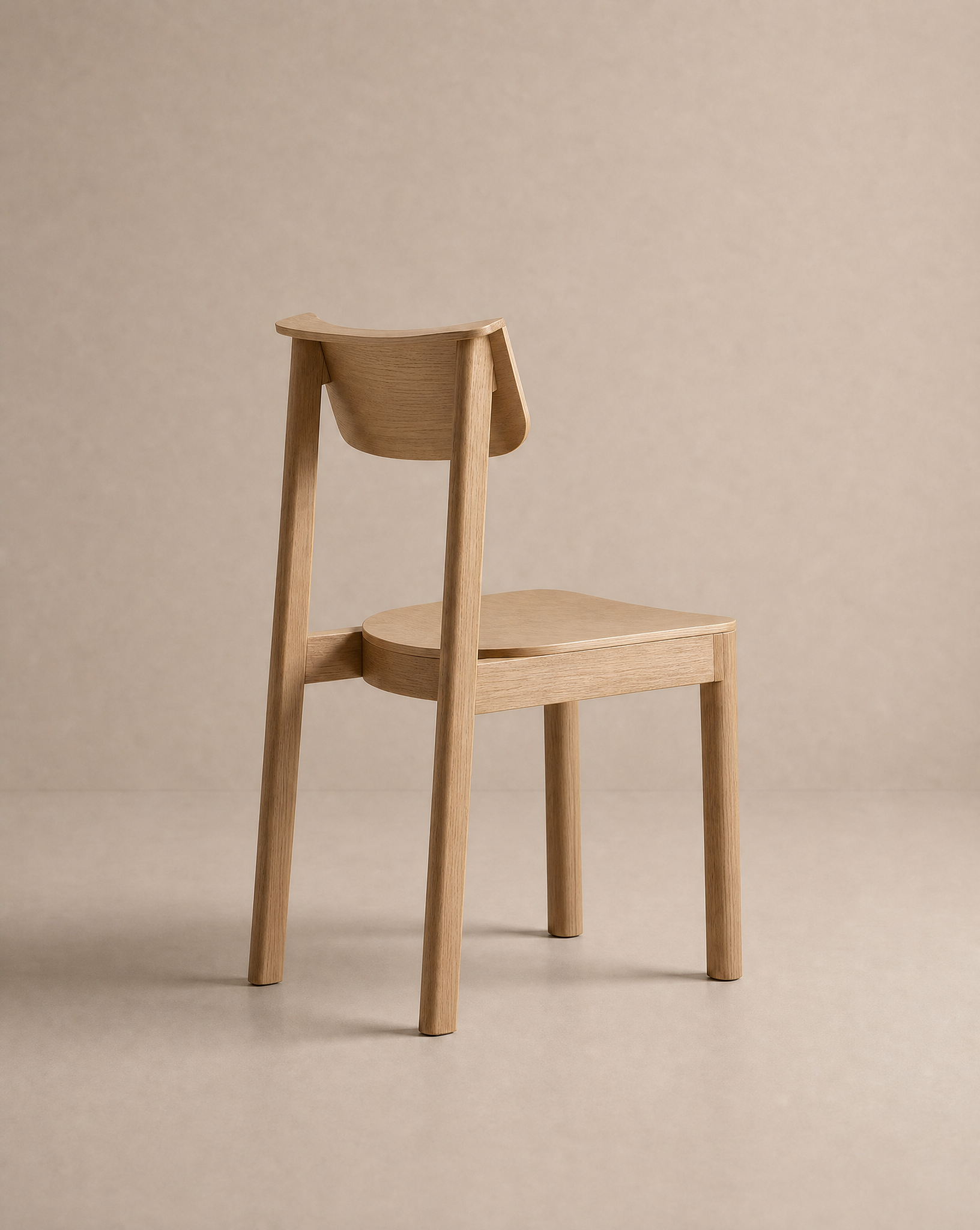 The Noki Dining Chair | Wood by Wooden Stories, featuring a curved backrest and clean, minimalist design in solid wood, is set against a neutral beige background with its back facing the viewer.