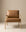 The Nysse Lounge Chair by Wooden Stories showcases modern Scandinavian style, with light wooden legs and frame, plus tan leather cushioned seat and backrest, set against a plain beige background.
