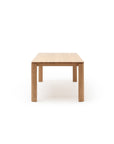 The Oli Dining Table by Wooden Stories is a minimalist piece from the Danish collection, crafted from solid American oak with four straight legs and a smooth rectangular surface, shown photographed end-on against a plain white background.