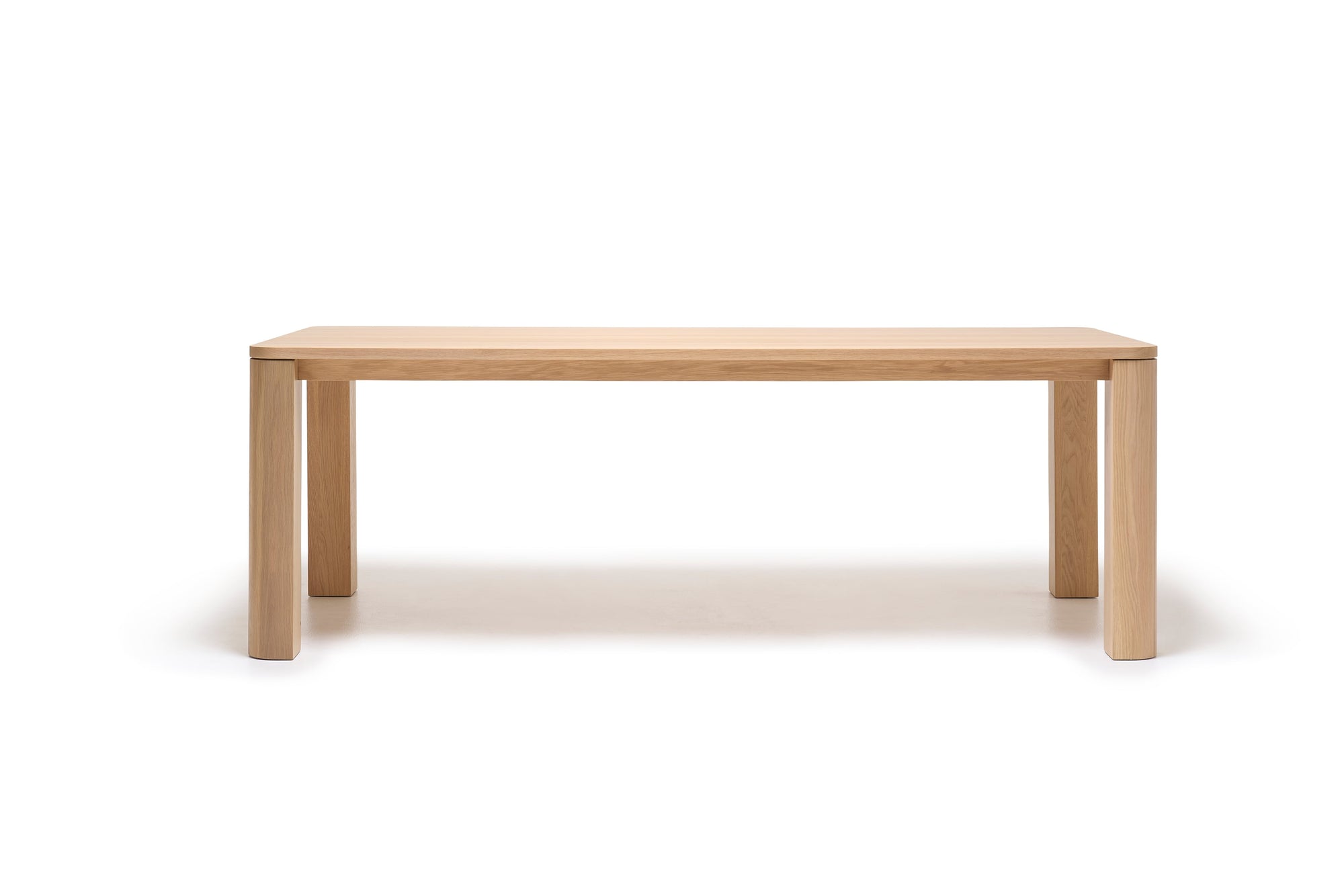 The Oli Dining Table by Wooden Stories features a minimalist rectangular design crafted from solid American oak with four straight legs. Shown on a plain white background, its smooth light wood finish reflects Danish-inspired elegance.