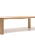 The Oli Dining Table by Wooden Stories is a rectangular dining table crafted from solid American oak, featuring four thick legs, a light natural wood finish, and a simple modern design inspired by the Danish collection.