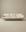 The Pensive Sofa | Fabric by Wooden Stories is a modern, minimalist Danish cream sofa with three seat cushions and wooden legs, shown against a plain beige background.