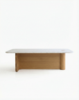 The Pivot Coffee Table | Rectangular - Stone & Wood by Wooden Stories features a white marble top and solid oak light wood base, shown against a plain white background.