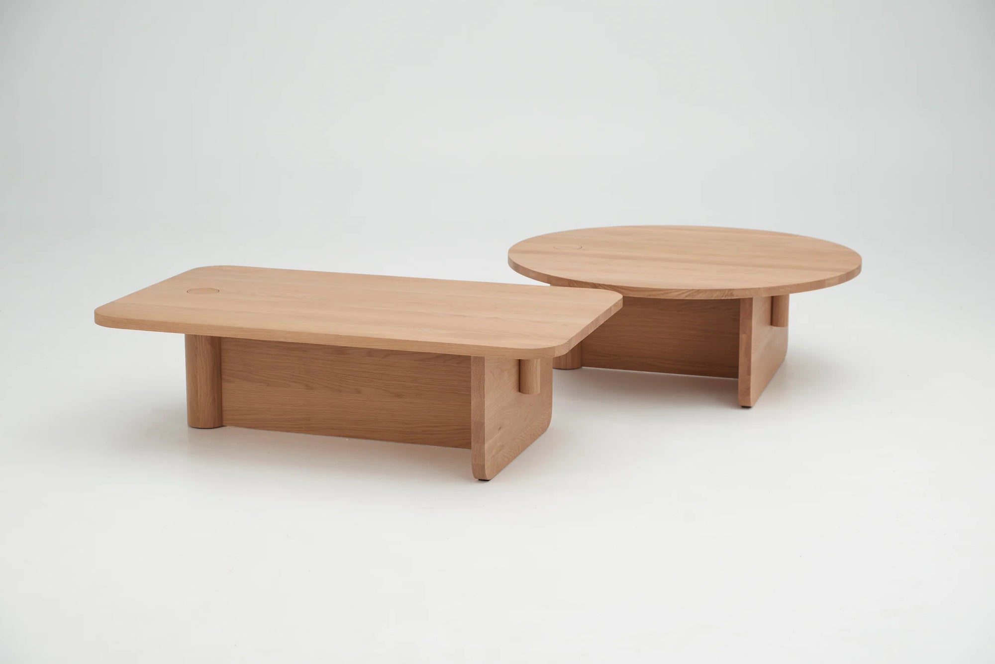 The Wooden Stories Pivot Coffee Table | Rectangular - Wood is a solid wood table with rounded edges, thick legs, and a natural finish—perfect for contemporary spaces with its simple, modern design.