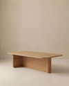 The Wooden Stories Pivot Coffee Table | Rectangular features a minimalist solid oak build with smooth edges, two sturdy legs with rounded corners, and a natural wood finish. Shown against a beige background, it's part of the Danish Collection.