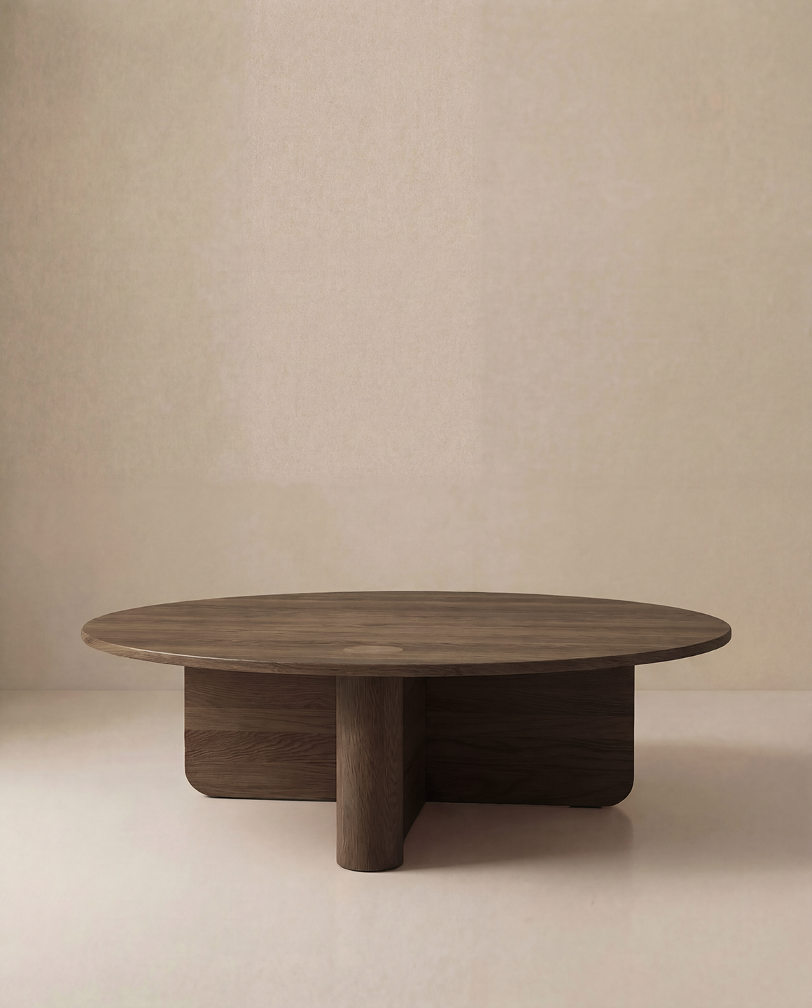 The Pivot Coffee Table | Round by Wooden Stories features a thick solid wood tabletop and geometric base, shown here against a plain beige background.
