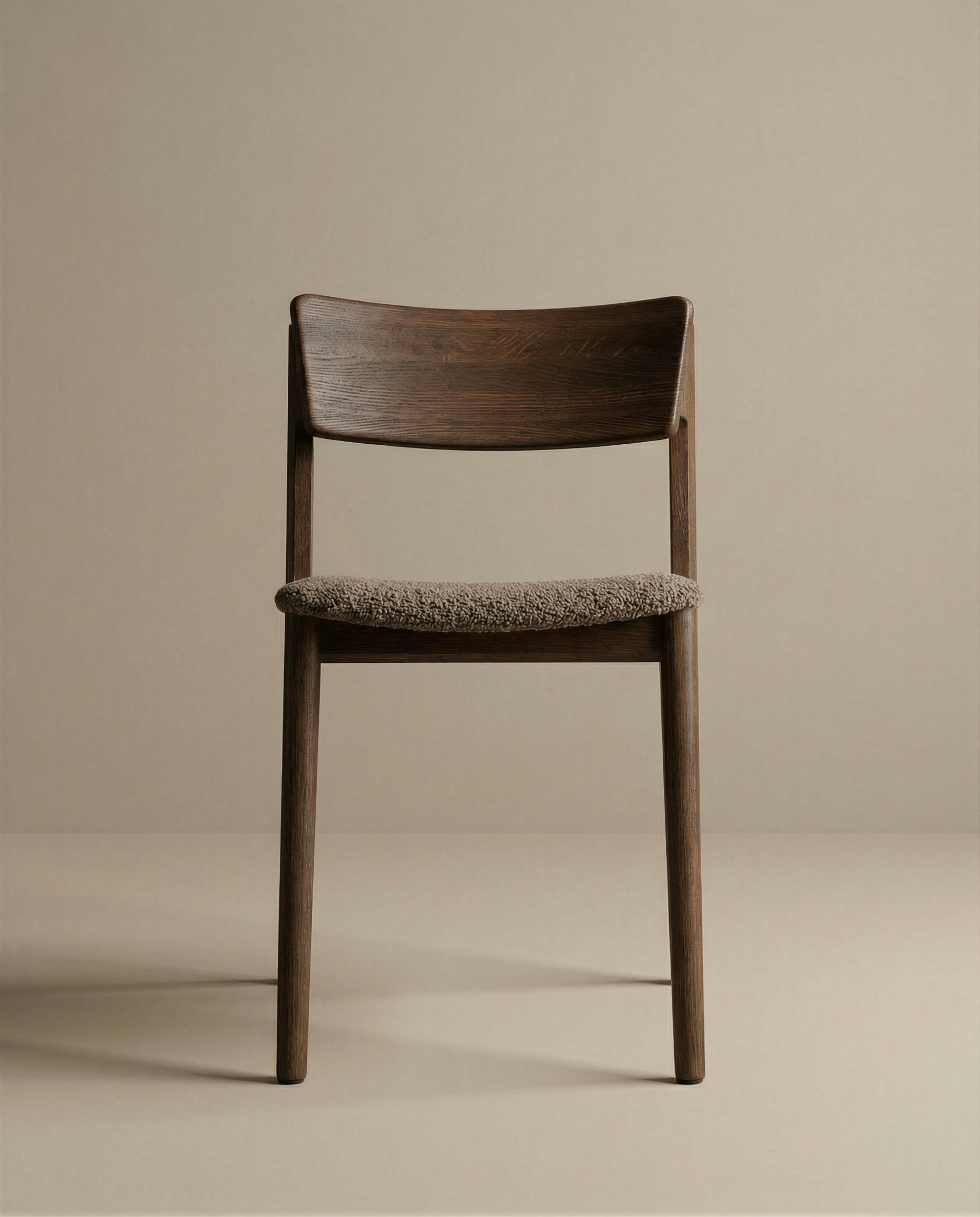 The Poise Dining Chair by Wooden Stories features an espresso oak frame and a textured fabric seat, photographed against a plain beige background.