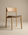 The Poise Dining Chair | Light Oak with Fabric by Wooden Stories features a light brown oak frame, curved backrest, and gray cushioned seat—perfect for contract grade spaces, shown against a plain beige background.