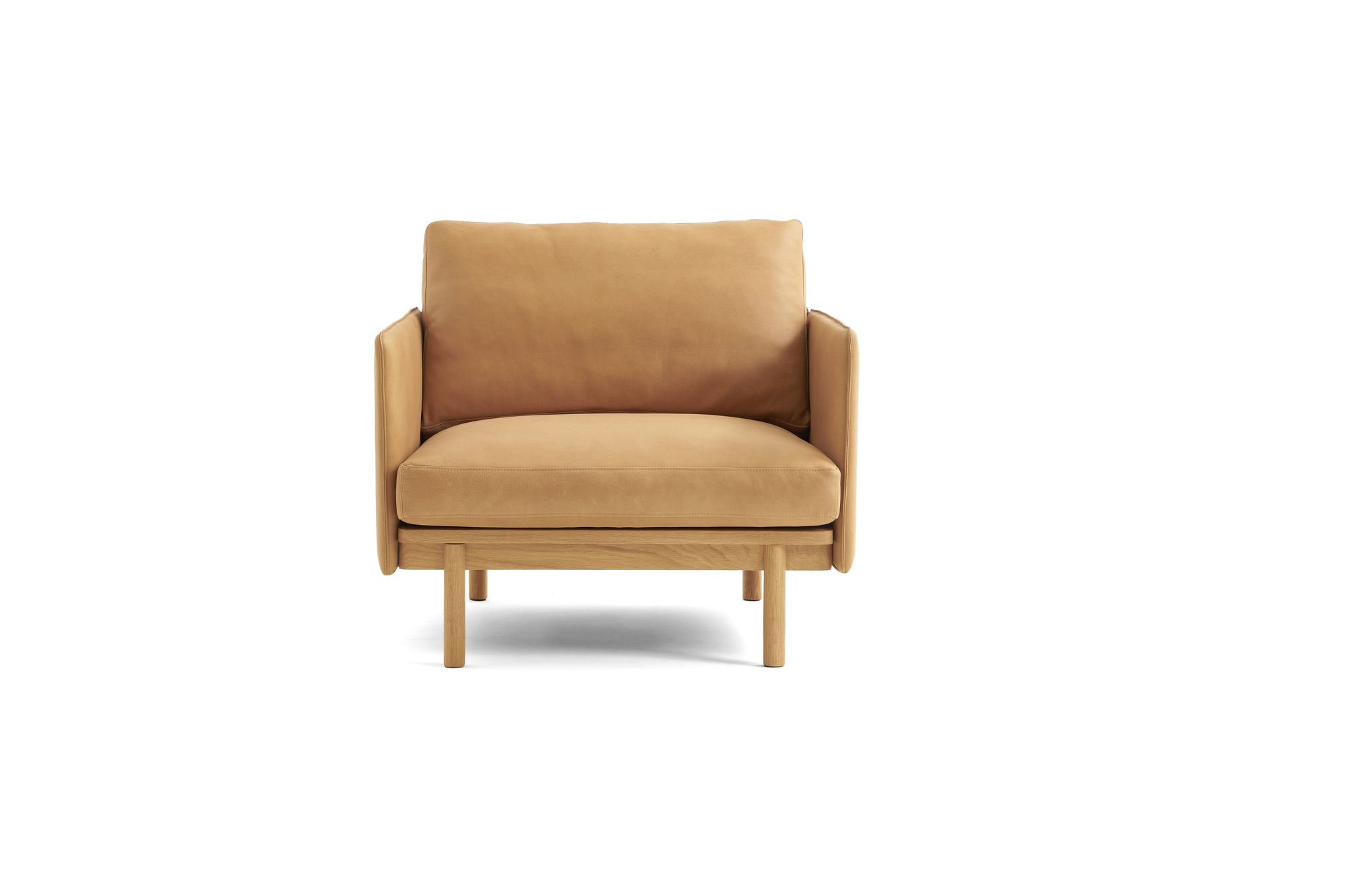 The Pensive Lounge Chair | Leather by Wooden Stories is a modern tan leather armchair with Danish-inspired lines, a wooden frame and legs, plus a cushioned seat and backrest—all set against a plain white background.