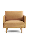 The Pensive Lounge Chair | Leather by Wooden Stories is a modern tan leather armchair with Danish-inspired lines, a wooden frame and legs, plus a cushioned seat and backrest—all set against a plain white background.