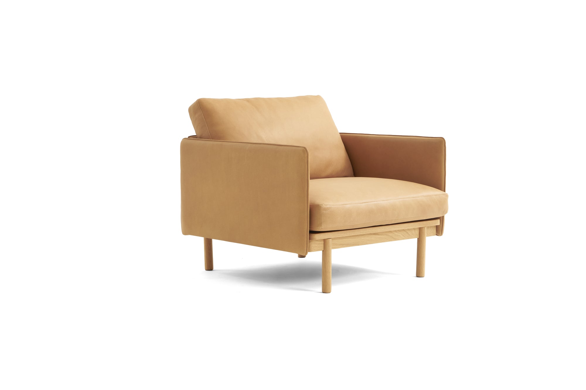 The Wooden Stories Pensive Lounge Chair | Leather features a modern tan design with Danish lines, wooden legs, a boxy silhouette, and plush seat and back cushions, shown against a white background.