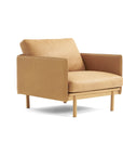The Wooden Stories Pensive Lounge Chair | Leather features a modern tan design with Danish lines, wooden legs, a boxy silhouette, and plush seat and back cushions, shown against a white background.