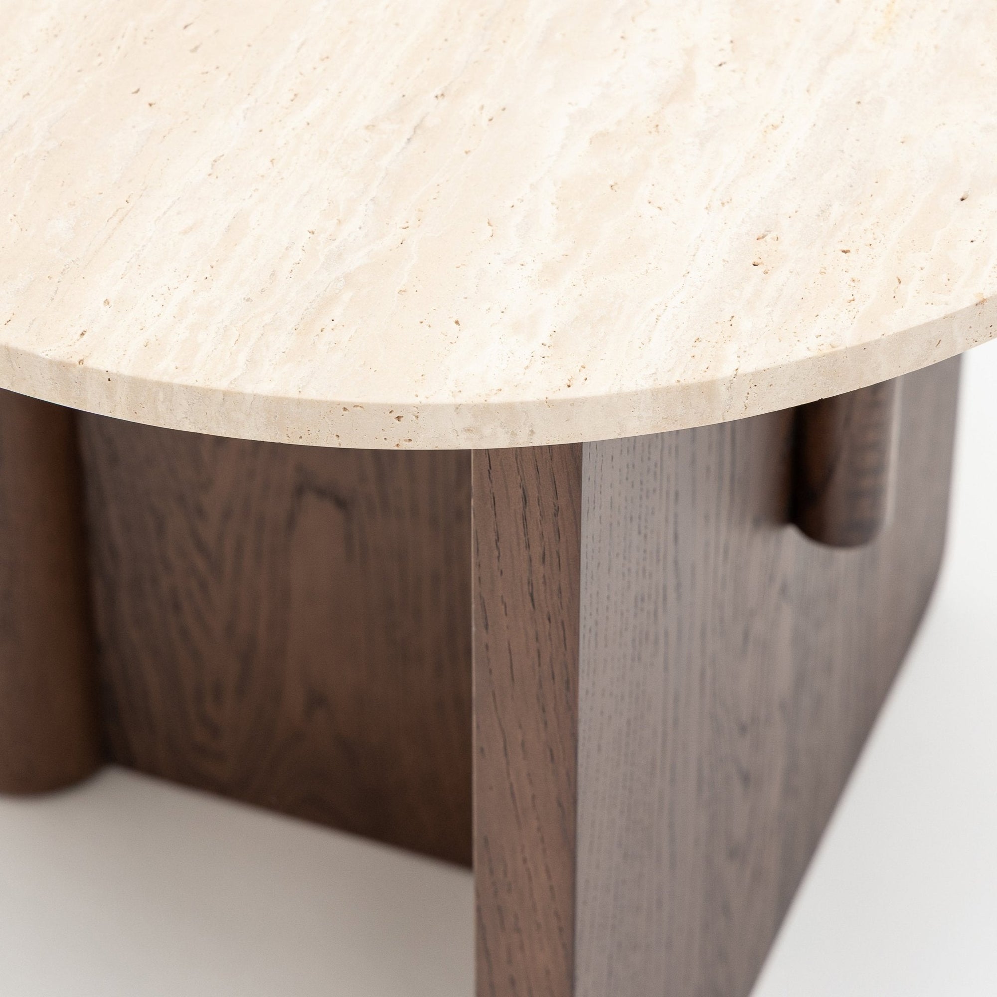 Close-up of the Wooden Stories Pivot Side Table in Espresso Oak, featuring a light stone top and dark geometric wooden legs.