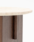 A close-up of the Wooden Stories Pivot Side Table in Espresso Oak, showcasing a contract-grade, honed stone top and a wooden base with vertical panels in varied brown tones against a plain white background.