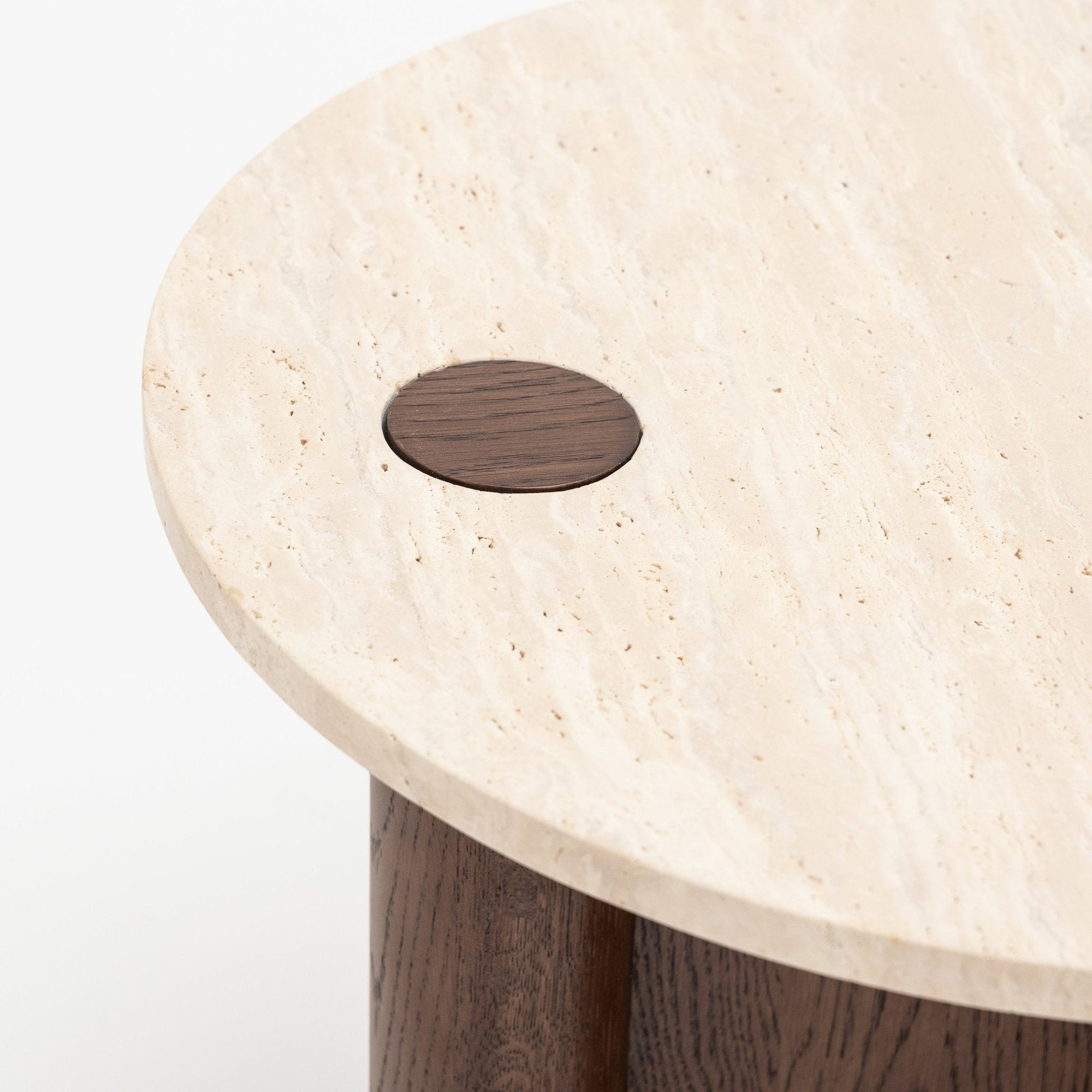 A close-up of the Pivot Side Table | Espresso Oak - Stone Top by Wooden Stories, showing its round honed marble top with a dark wood inlay and cylindrical espresso oak leg—a refined, contract-grade piece.