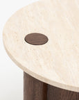 A close-up of the Pivot Side Table | Espresso Oak - Stone Top by Wooden Stories, showing its round honed marble top with a dark wood inlay and cylindrical espresso oak leg—a refined, contract-grade piece.