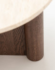 Close-up of the Wooden Stories Pivot Side Table | Espresso Oak - Stone Top, featuring a light honed stone round top and dark espresso oak cylindrical legs, highlighting the striking contrast in materials and textures.