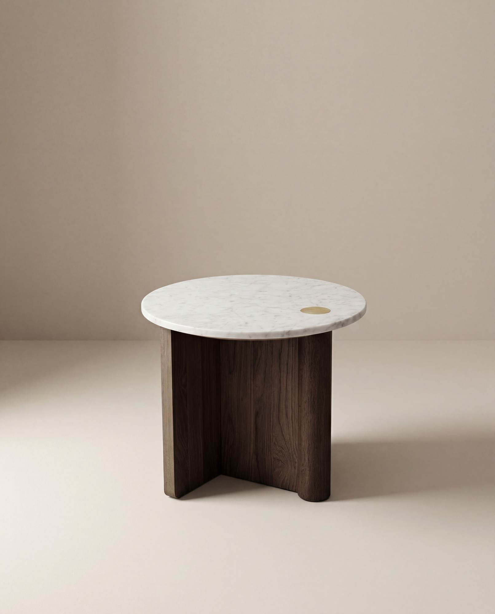 The Pivot Side Table | Wood &amp; Stone by Wooden Stories features a white marble top, dark solid oak base, and a small brass inlay, all against a plain beige background. Inspired by the Danish Collection.