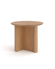 The Pivot Side Table by Wooden Stories features a simple, modern design with a smooth solid oak top and three flat, wide legs that intersect at the center. Its small, round shape makes it a versatile Danish-inspired accent piece.