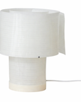 The RUSSO BETAK STUDIO Snegl Scallop Table Lamp offers a modern minimalist look with a cylindrical base, spiral translucent shade, white cord, and soft glow inspired by the sea.