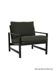 The Troubadour Lounge Chair | Fabric by Wooden Stories features dark green cushions and a sleek solid oak frame in a modern mid-century design, shown here on a white background and inspired by the iconic Danish collection.